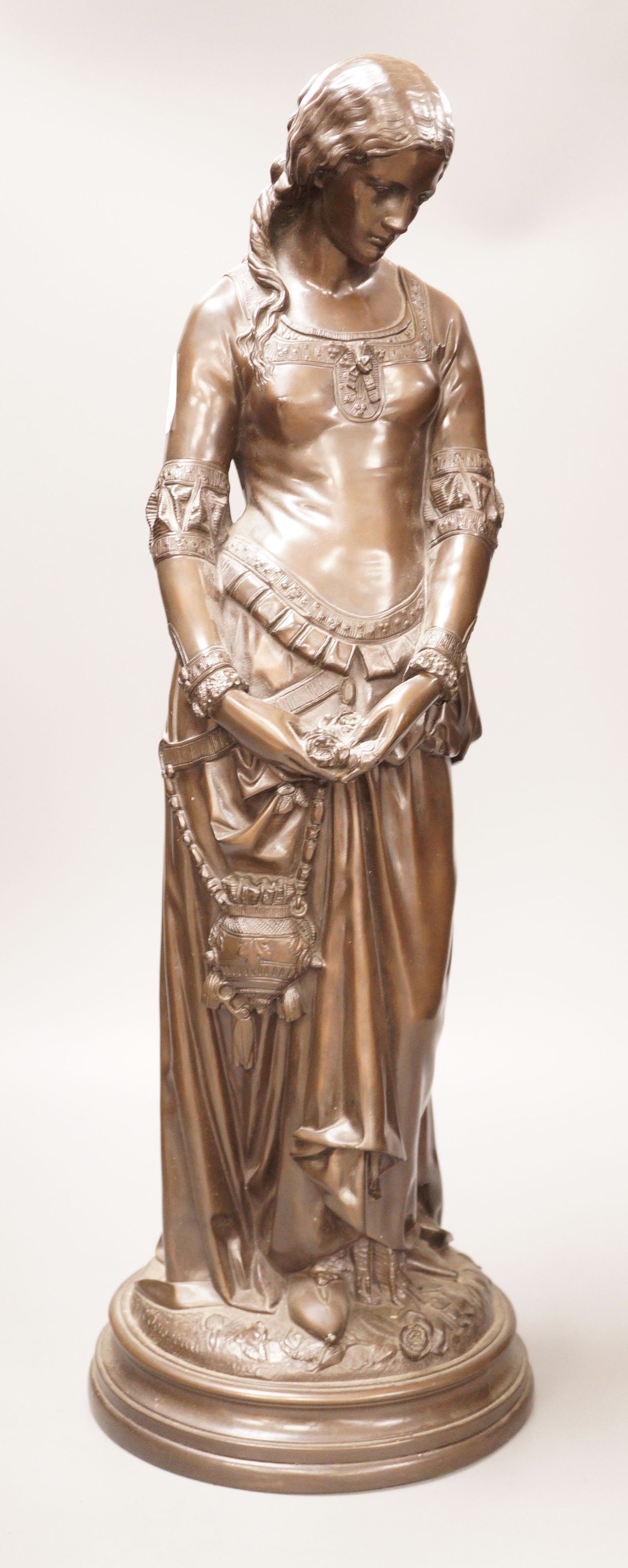 After Boisseau, a tall bronzed metal figure of a standing maiden, signed to verso, 58cm tall